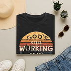 Christian T-Shirt — "God’s Still Working on My Attitude" Retro Sun Graphic
