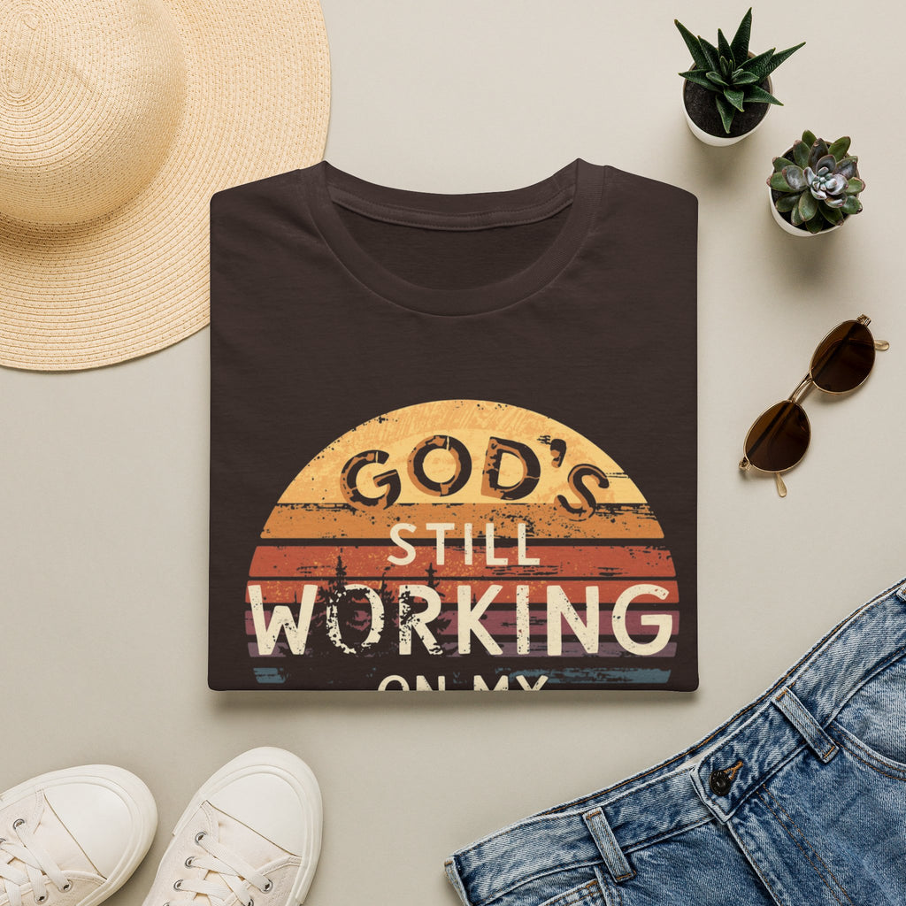 Christian T-Shirt — "God’s Still Working on My Attitude" Retro Sun Graphic