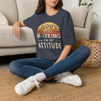 Christian T-Shirt — "God’s Still Working on My Attitude" Retro Sun Graphic