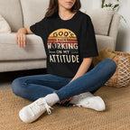 Christian T-Shirt — "God’s Still Working on My Attitude" Retro Sun Graphic